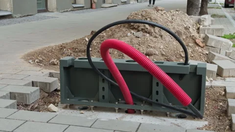 Unearthed cable conduit on pavement. City street with visible underground cables Stock Footage 335143788