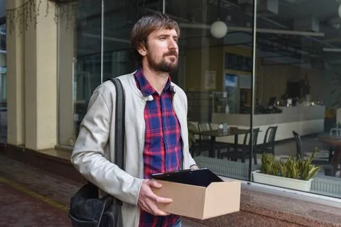 An unemployed manager with a box of documents lost his job due to the global Stock Photos