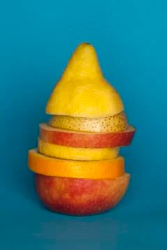 Uneven slices of different fruit stacked to comprise the shape of a piece of Foto stock