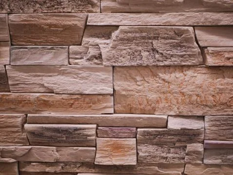 Uneven stone facade close-up. Torn stone texture. Stone wall. Stonewall abstr Foto stock