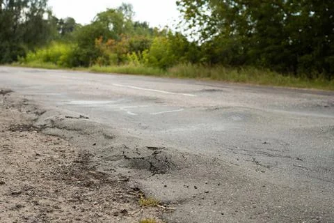 Uneven surface of asphalt road Stock Photos