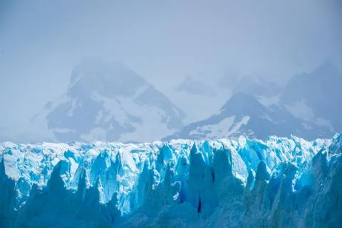 The uneven surface of the glacier shines in the sunlight. Shevelev. Stock Photos