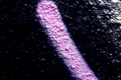 The uneven wall texture background was painted with pink and black paint Stock Photos