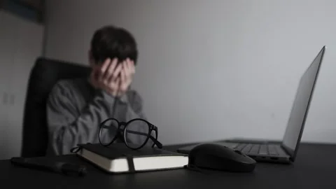 Unexpected project failure reaction, man at desk in home office covering face Stock Footage 329626495