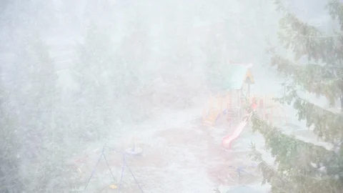 Unexpected snow in the spring. Strong blizzard in the spring in the city. Stock Footage 129948699