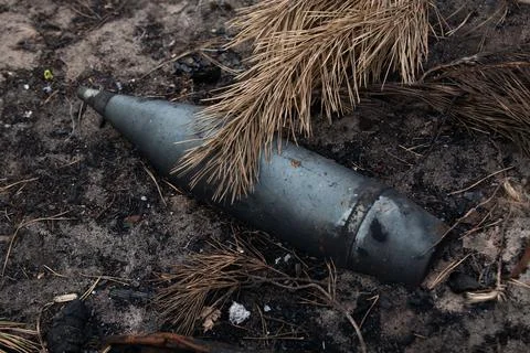 An unexploded artillery shell on the ground Stock Photos