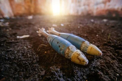 Unexploded mortar mines on ground. War actions aftermath Stock Photos