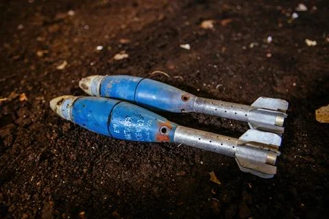 Unexploded mortar mines on ground. War actions aftermath Stock Photos