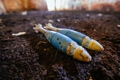 Unexploded mortar mines on ground. War actions aftermath Stock Photos