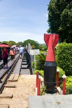 Unexploded projectile on the background of the road of death. Stock Photos
