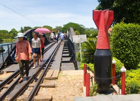 Unexploded projectile on the background of the road of death. Stock Photos
