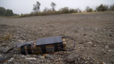 UNEXPLODED ROADSIDE BOMB WITH CELL PHONE TRIGGER. Stock Footage 76411986