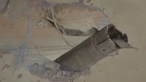 An unexploded shell hit the apartment. Hole in the wall. War in Ukraine. Stock Footage 194287880