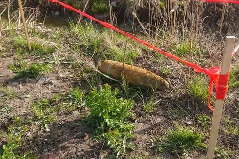 An unexploded shell from World War II found in a forest. Stock Photos