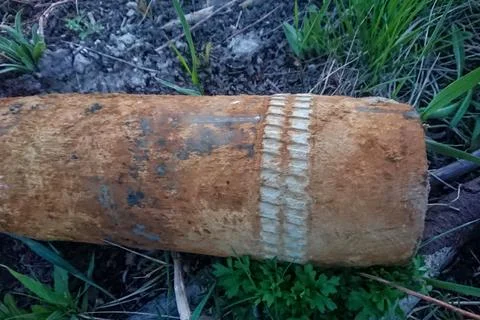An unexploded shell from World War II found in a forest. Stock Photos
