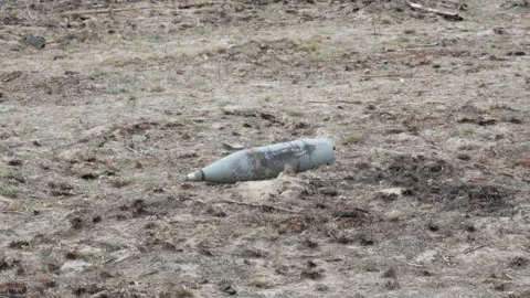 Unexploded shells on the ground Видео 195807654