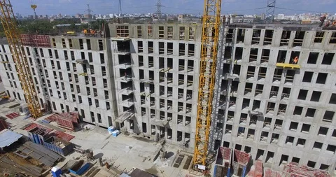 Unfinished apartment complex with builders on the top, aerial Stock Footage 124621042