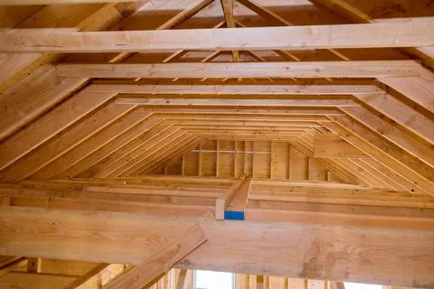 Unfinished attic of private house residential construction house framing agai Stock Photos