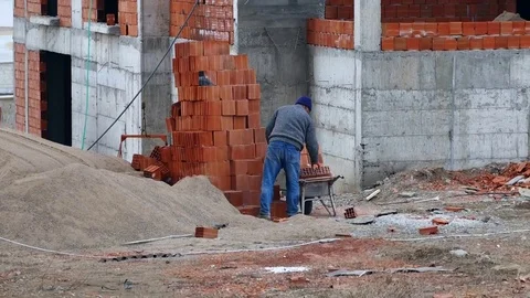 Unfinished building construction and worker Stock Footage 104570273