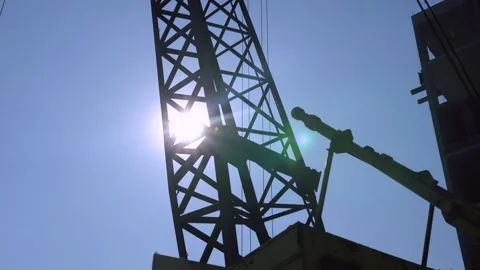 An unfinished building with a working construction crane Stock Footage 251711175