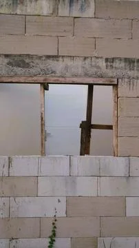 Unfinished concrete block wall with a rectangular window opening under construct Stock Photos