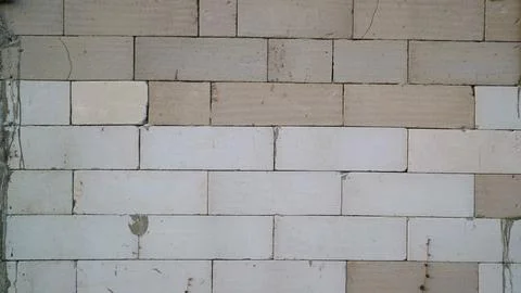 Unfinished concrete block wall with a rectangular pattern under construct Stock Photos