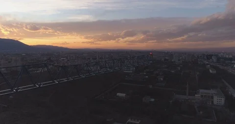 Unfinished concrete building with construction tower crane against mesmerising Stock Footage 125520719