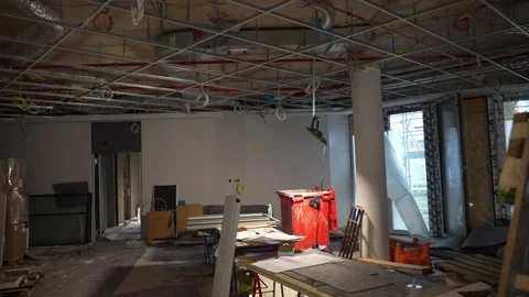 Unfinished construction interior with exposed ceiling grid and materials Stock Footage 332584216