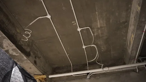 Unfinished electrical installations on a concrete ceiling Stock Footage 271571138