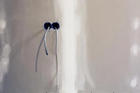 Unfinished electrical mains outlet socket with electrical wires installed in Stock Photos