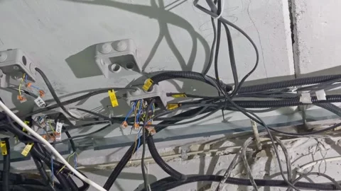 Unfinished electrical wiring with corrugated cable ducts and labeling on a .. Stock Footage 338254249