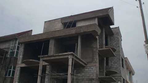 Unfinished ground plus homes view from a lower angle Stock Footage 97569821