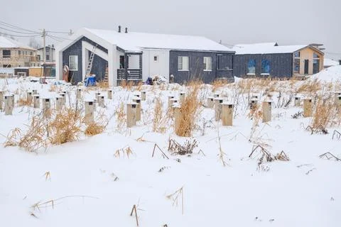 Unfinished house construction in winter with snow covered landscape and visible Stock Photos