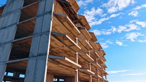 Unfinished multi-storied building façade exterior. Low angle view. Lovely blue Stock Footage 321764978