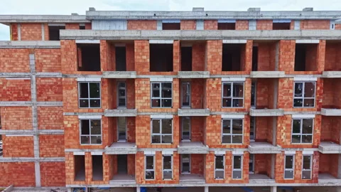 Unfinished residential structure showcasing raw brick and concrete details. Stock Footage 337906267