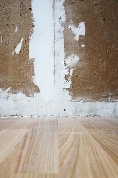 Unfinished wall with patchy plaster and filler marks before repainting. Raw s Stock Photos