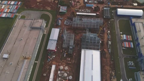 Unfinished workshop buildings at open construction site Видео 138207415