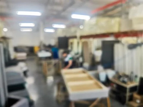 Unfocused background photo of workers assembling upholstered furniture in a f Фото