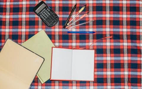 Unfolded notebooks with white sheets on a colored background in a cell Stock Photos