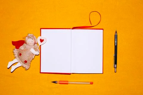 Unfolded notebooks with white sheets on a colored background in a cell Stock Photos