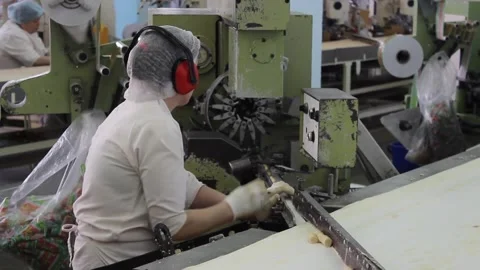 Unglazed white candy bars move on a conveyor belt in a candy factory. Stock Footage 128643096