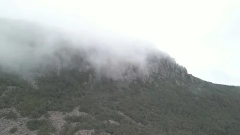 Ungraded Dramatic 4K Pan of a misty mountain Stock Footage 230058296