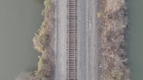 Ungraded - Drone Flying over Marsh, Island &amp; Railroad near River Stock Footage 311609336