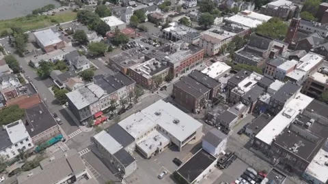 Ungraded - Drone Flying over Progressive Riverfront Town w/ Sailboats Stock Footage 312714422