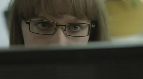 Ungraded: Girl With Eyeglasses Looks Into Computer Monitor Stock Footage
