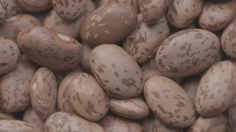 Ungraded video of rotating marble beans shot from above Stock Footage 119212876