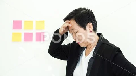 Unhappy Asian senior manger problems facial expression Stock Photos
