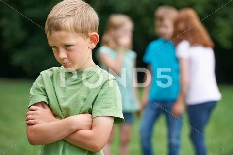 Unhappy Boy Being Gossiped About By Other Children Stock Photos