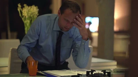 Unhappy businessman comparing data on smartphone and documents on sofa HD. Stock Footage 44560391