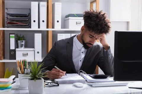 Unhappy Businessman Working In Office Stock Photos